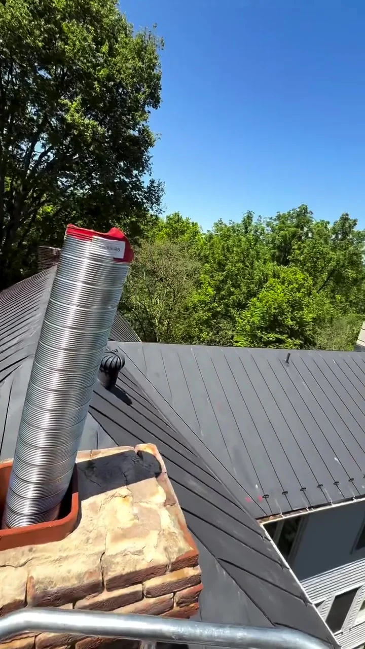 Chimney technician working at roof level during a system evaluation — mobile service overview