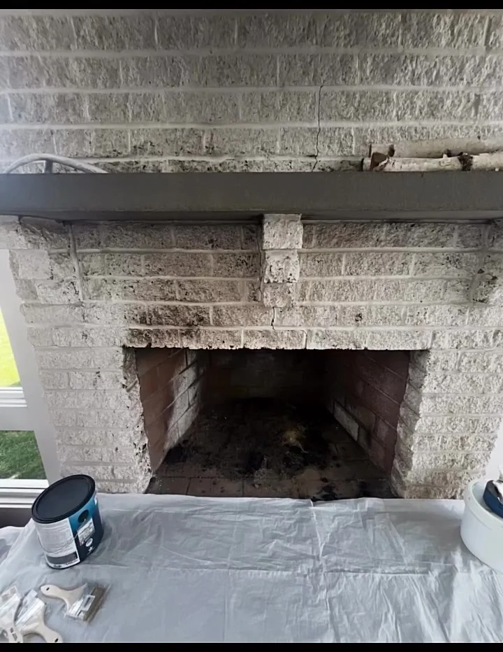 Soot-darkened light-brick fireplace before restoration in Leesburg, Virginia
